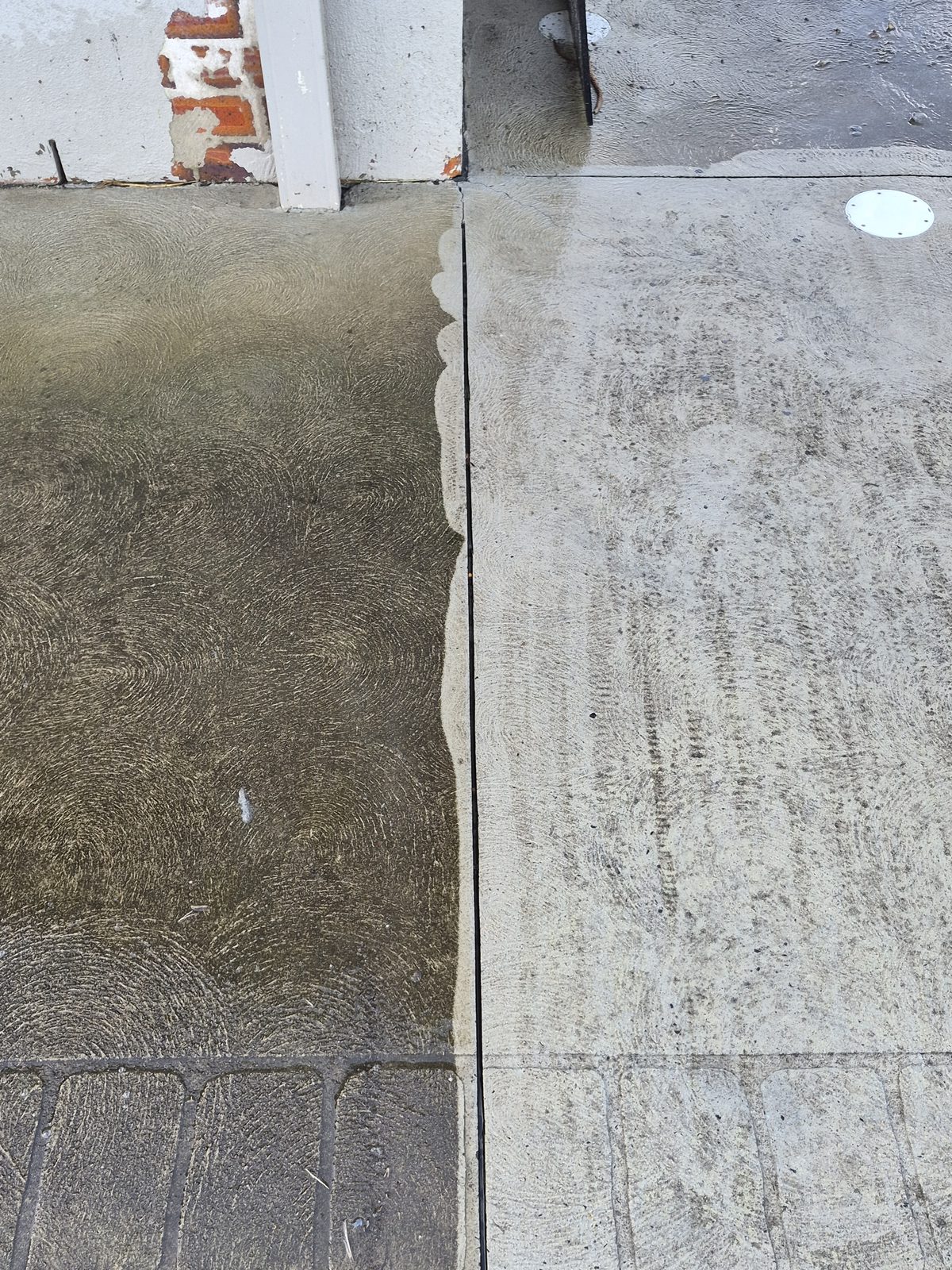 Concrete driveway pressure cleaning, dirty section versus freshly cleaned section