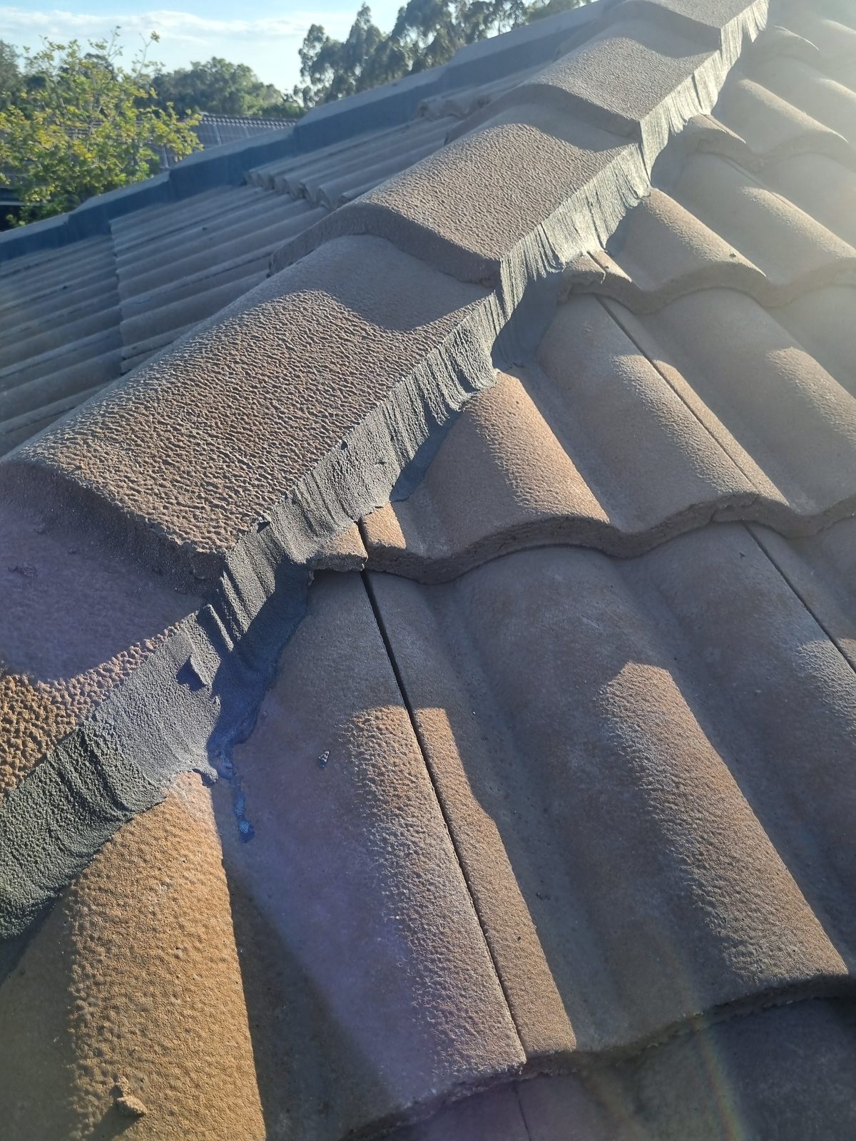 Close-up of freshly pointed ridge capping with excess pointing compound visible